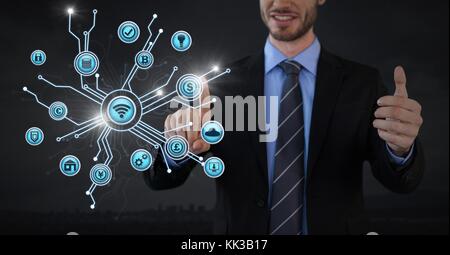 Digital composite of Businessman touching various business icons  interface Stock Photo