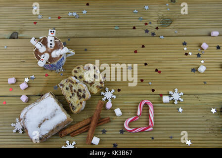 Christmas food and drink photography image with hot chocolate cup and mini marshmallows shaped as snowman with iced on smile with candy cane heart Stock Photo