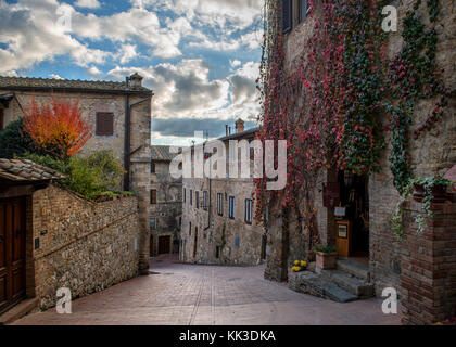 beautiful old street with flowers on brick walls Stock Photo