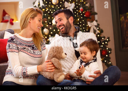 Beautiful cheerful young family have fun on Christmas Stock Photo