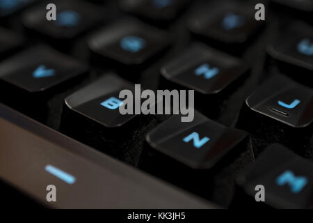 The mechanical backlighted keyboard black keycap with blue backlight detail. This image could be used as a theme of pc games. Stock Photo