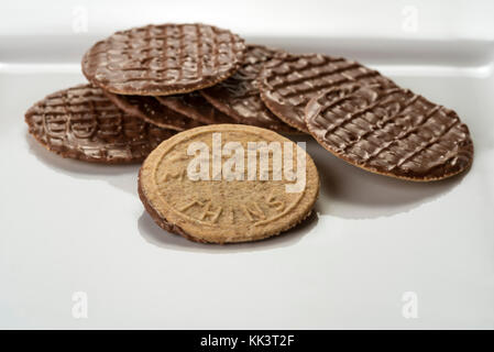 McVities Thins on a white square plate, chocolate biscuits. Stock Photo