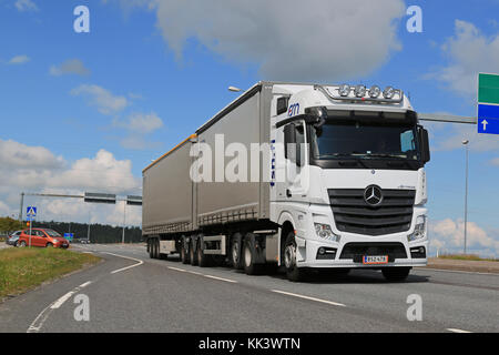 SALO, FINLAND - JULY 17, 2015: White Mercedes-Benz Actros 2551 truck-trailer in traffic. Mercedes-Benz Actros wins The Green Truck 2015 Award. Stock Photo