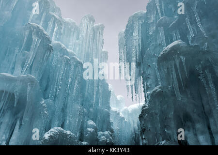 Translucent blue icicles in a frozen ice wall. Stock Photo