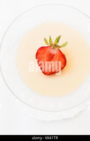 Creamy traditional Italian jelly dessert called Panna Cotta which is made of heavy cream, milk, vanilla and gelatin served in a cocktail glass and dec Stock Photo