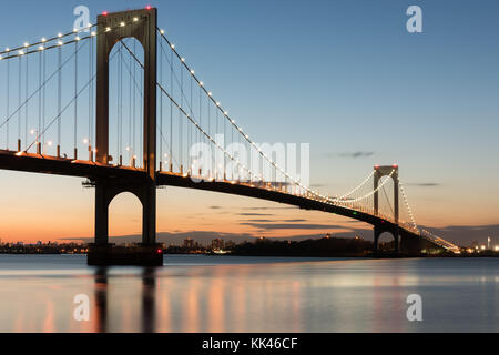 The Bronx-Whitestone Bridge reflecting on the East River at night in New York. Stock Photo