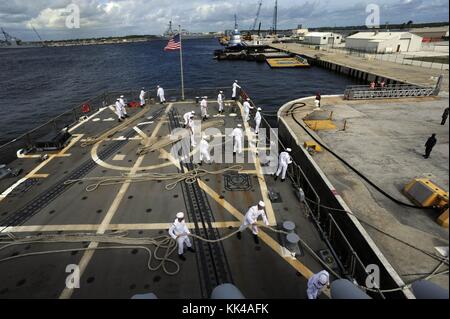 Sailors aboard the guided-missile destroyer USS Farragut DDG 99 heave in lines before getting underway, Mayport, Florida, 2012. Image courtesy U.S. Navy Photo by Mass Communication Specialist 3rd Class A.J. Jones/US Navy. Stock Photo