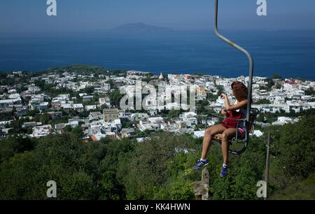 Premium Photo  Chair lifts in capri island town at naples in italy.  landscape with deck chairs and blue mediterranean sea at italian coast.  anacapri in europe. view on summer. amalfi scenery.