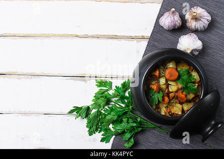 potatoes with mushrooms in a clay pot. Mushrooms from the forest Stock Photo