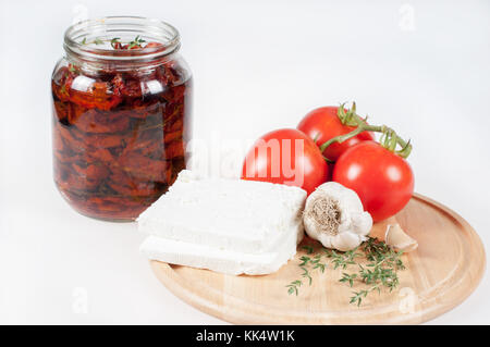 Tomatoes, cheese, dried tomatoes, garlic and thyme Stock Photo