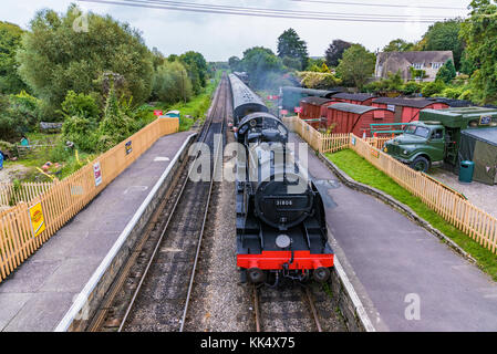 CORFE, UNITED KINGDOM - SEPTEMBER 08: This is an old British steam train passing through the medieval village of Corfe on September 08, in Corfe Stock Photo