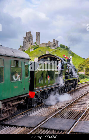 CORFE, UNITED KINGDOM - SEPTEMBER 06: This is a traditional British steam train passing through the medieval town of Corfe on September 06, in Corfe Stock Photo