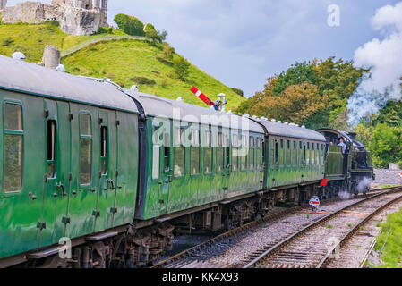 CORFE, UNITED KINGDOM - SEPTEMBER 06: This is a traditional British steam train passing through the medieval town of Corfe on September 06, in Corfe Stock Photo