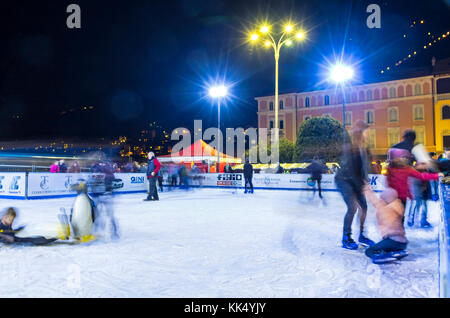 Ice skaters having fun on skating rink at annual traditional Christmas fair on Piazza Cavour in center of Como old town, Italy Stock Photo