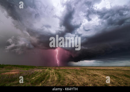 Lightning strike from a severe thunderstorm and illuminates dark storm clouds Stock Photo