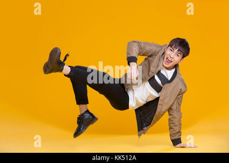 Cheerful young Chinese man dancing Stock Photo