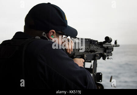 ATLANTIC OCEAN (Nov. 8, 2017) Master-At-Arms 1st Class Joseph Blair from Fort Worth, Texas, fires an M240B machine gun during a live-fire exercise aboard the amphibious assault ship USS Iwo Jima (LHD 7). Iwo Jima, components of the Iwo Jima Amphibious Ready Group and the 26th Marine Expeditionary Unit are conducting a Combined Composite Training Unit Exercise that is the culmination of training for the Navy-Marine Corps team and will certify them for deployment. (U.S. Navy photo by Mass Communication 3rd Class Daniel C. Coxwest/Released) Stock Photo