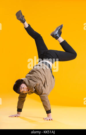 Cheerful young Chinese man dancing Stock Photo