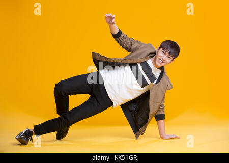 Cheerful young Chinese man dancing Stock Photo