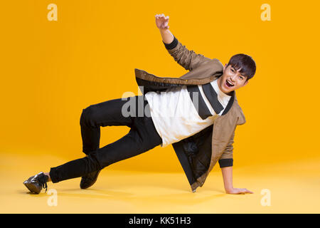 Cheerful young Chinese man dancing Stock Photo