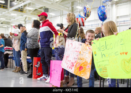 Children react as Soldiers from the 10th Combat Aviation Brigade enter a hangar during a redeployment ceremony at Fort Drum, New York, on November 9. The brigade was returning from a nine-month rotation to Europe support Atlantic Resolve, a U.S. Army Europe operation to assure NATO Allies of the United State's commitment to the alliance and deter foreign agression. (U.S. Army photo by Spc. Thomas Scaggs) 171190-A-TZ475-037 Stock Photo