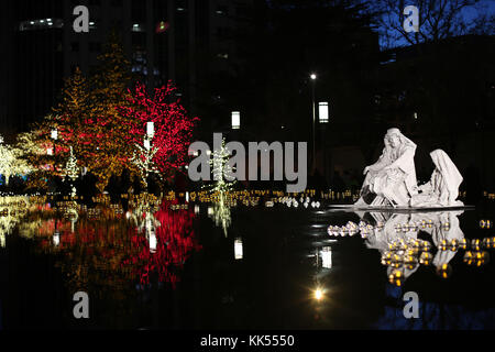 Joseph, Mary and the Christ child appear to be floating on the reflecting pond at Temple Square. Christmas Lights Temple Square, Salt Lake City, Utah. Christmas scene with figurines. Stock Photo