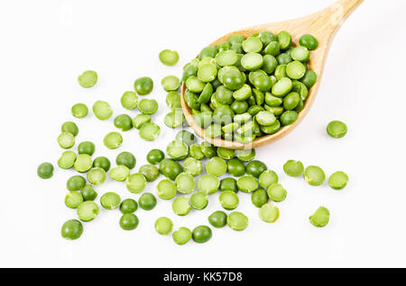 Dried split peas in a wooden spoon on a white background. Stock Photo