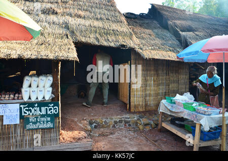 Asian thai old woman people sale food and salt from rock salt Indigenous Knowledge for travelers people at Ban Bo Kluea village on April 30, 2011 in N Stock Photo