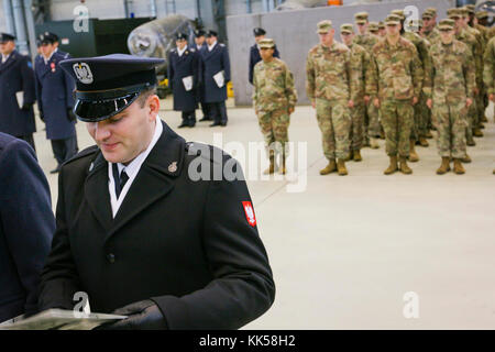 A Polish airman (left) with the 3rd Airlift Wing is promoted in front of a formation of U.S. Soldiers assigned to 497th Combat Sustainment Support Battalion, 6th Sustainment Brigade, 21st Theater Sustainment Command during a ceremony in Powidz, Poland, Nov. 10, 2017. The U.S. Soldiers are deployed to Poland in support of Atlantic Resolve, a U.S. endeavor to fulfill NATO commitments by rotating U.S.-based units throughout the European theater to deter aggression against NATO allies in Europe. (U.S. Army photo by Spc. Hubert D. Delany III/22nd Mobile Public Affairs Detachment) Stock Photo