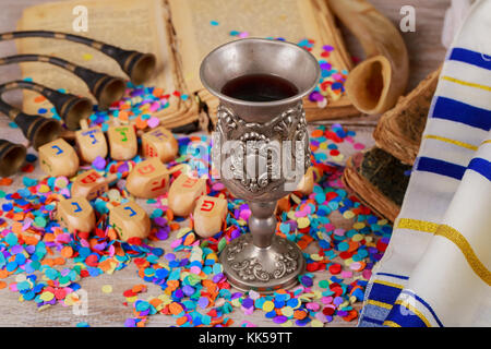 Jewish holiday Hanukkah wine Hanukkah menorah with of Hanukkah dreidels in rustic setting Chanukah wooden dreidels on a wood surface. Stock Photo