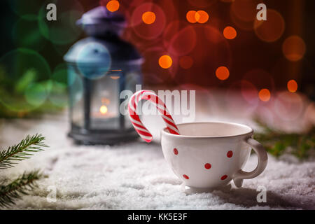 Christmas candy cane in dotted tea cup Stock Photo