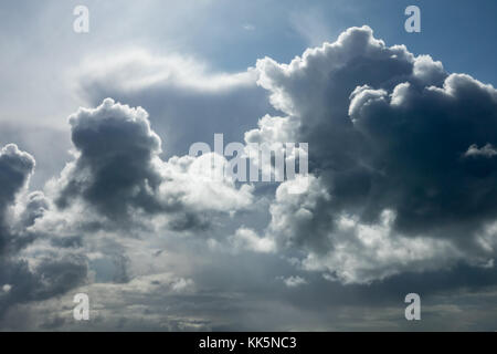 Dramatic Autumn clouds backlit by Sun. Stock Photo