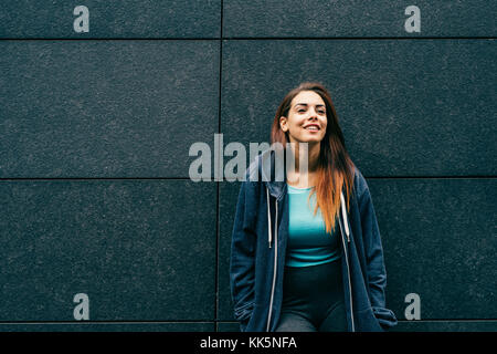 young woman mixed race outdoors posing looking sideway Stock Photo