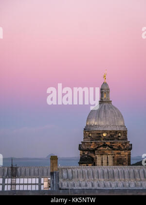 Sunset view of rooftop skyline, Old College dome, University of Edinburgh, Edinburgh, Scotland, UK, with pink sky sunset Stock Photo