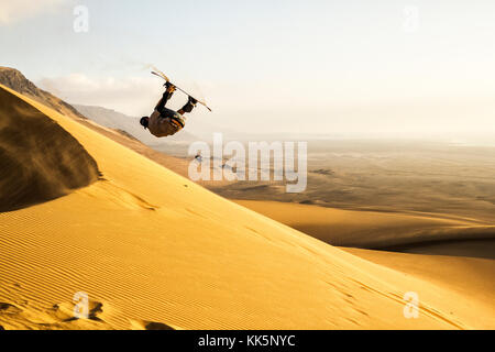 Sandboarding on Caramucho dunes, in Atacama Desert. Iquique, Tarapaca Region, Chile. Stock Photo