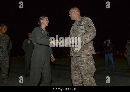 AGUADILLA, Puerto Rico – U.S. Army Lt. Gen. Jeffrey S. Buchanan, United States Army North commander, presents a challenge coin to a Marine, a crew chief with Marine Medium Tiltrotor Squadron 264, at Rafael Hernández Airport, Nov. 10, 2017. The Marine served on missions delivering supplies to communities in the mountains. (U.S. Army photo by Sgt. Avery Cunningham) Stock Photo