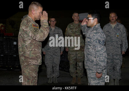 AGUADILLA, Puerto Rico – A U.S. Airman salutes Army Lt. Gen. Jeffrey S. Buchanan, left, United States Army North commander, after receiving a challenge coin at Rafael Hernández Airport, Nov. 10, 2017. The airmen were part of the emergency response after Hurricane Maria hit Puerto Rico. (U.S. Army photo by Sgt. Avery Cunningham) Stock Photo