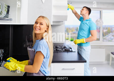 Young family couple doing cleaning in the house. Stock Photo