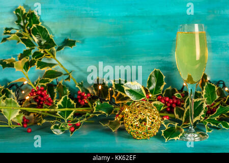 Christmas background with holly, champagne, and copy space Stock Photo