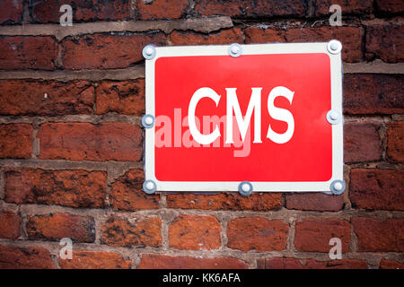 Hand writing text caption inspiration showing CMS concept meaning CMS WWW written on old announcement road sign with background and space Stock Photo