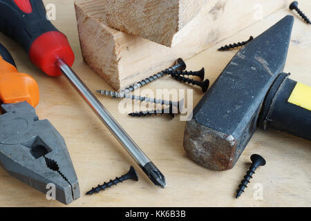 House renovation. Various tools and screws on a wooden background. Stock Photo