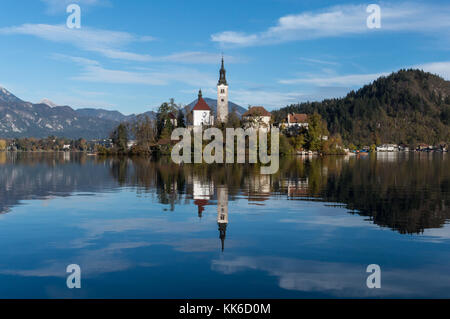 The church on the island in the middle of lake Bled reflecting perfectly in its waters Stock Photo