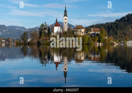 Close up of the Bled island and church being reflected in the lake's crystal clear waters Stock Photo