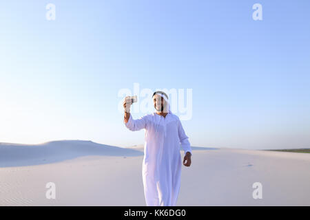 Portrait of Arabian sheikh man with gadget that communicates in  Stock Photo