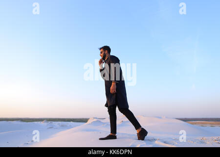 Handsome male Arab businessman talks on cellular business pro, s Stock Photo