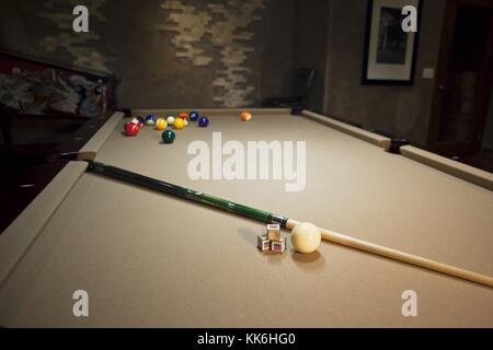 pool table with pool balls and stick Stock Photo