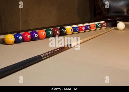 stick on pool table white ball arranged at cushion Stock Photo