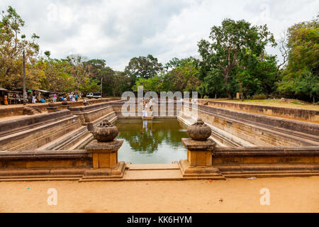 Anuradhapura, Sri Lanka - Jul 15, 2011 : View of ancient Kuttam Pokuna (twin ponds) at the ancient city Anuradhapura in Sri Lanka. Embankments were co Stock Photo