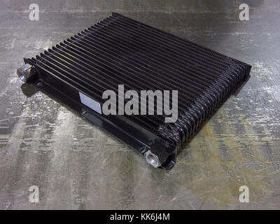convective cooling radiator. Spare part for industrial equipment or vehicle on an  iron surface Stock Photo