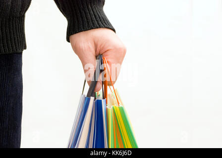 male hand holding a set of colorful shopping bags Stock Photo